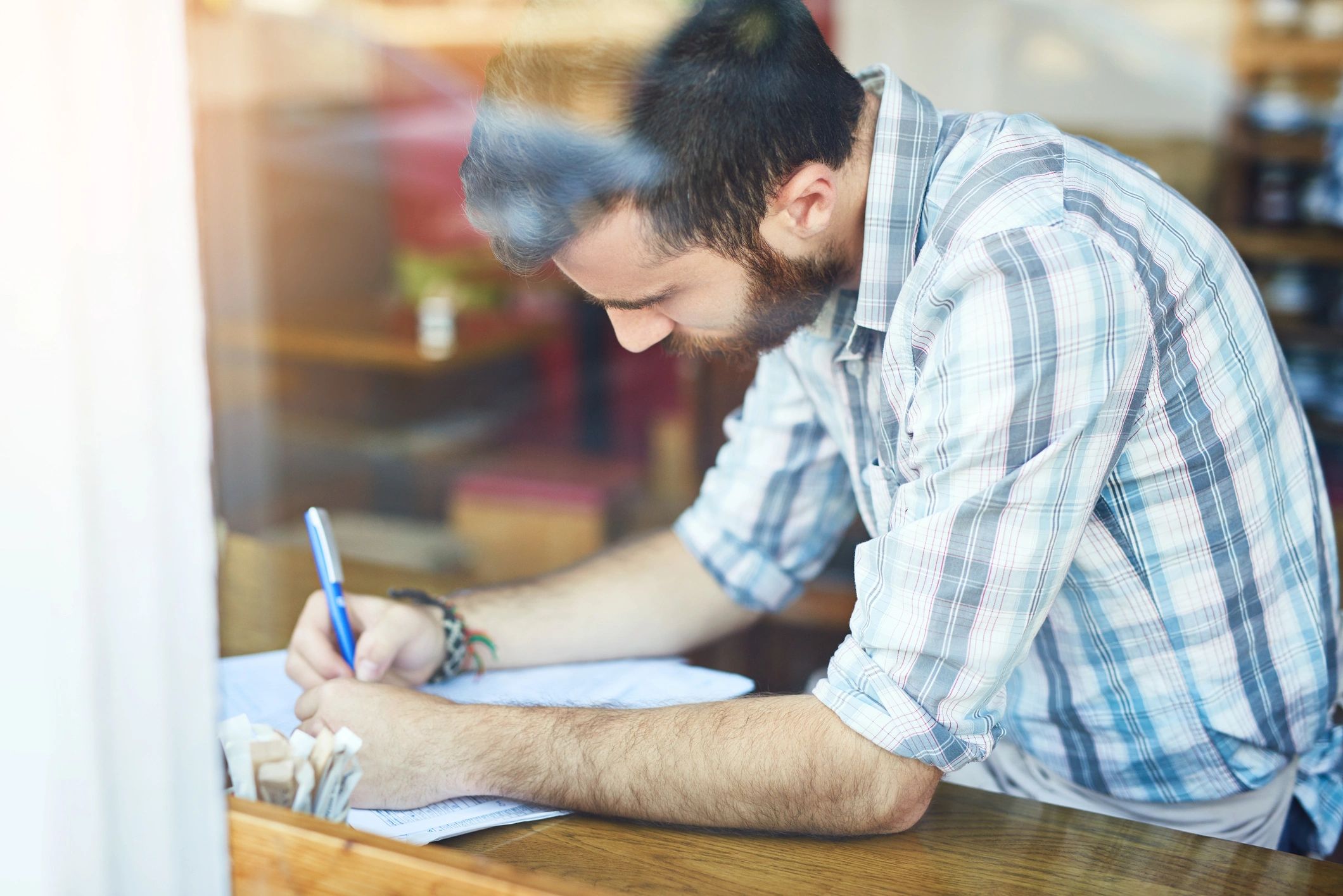Author working on manuscript paperwork
